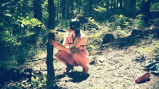 Beautiful slut totally naked in the forest sucking a dildo